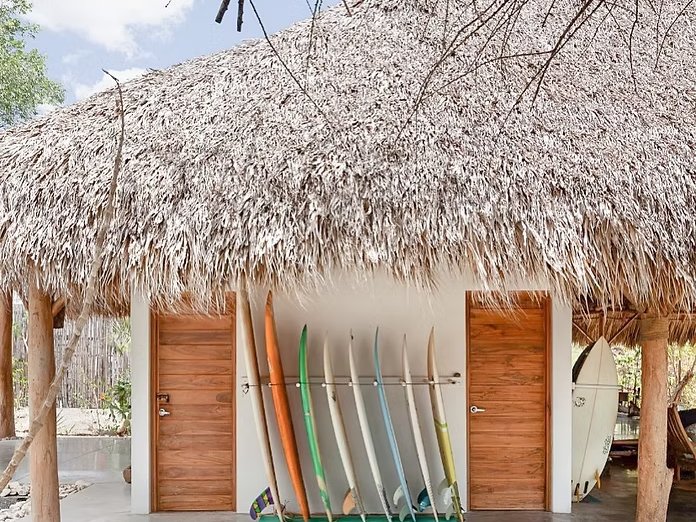 Surf boards lined up against a beach building in Nicaragua